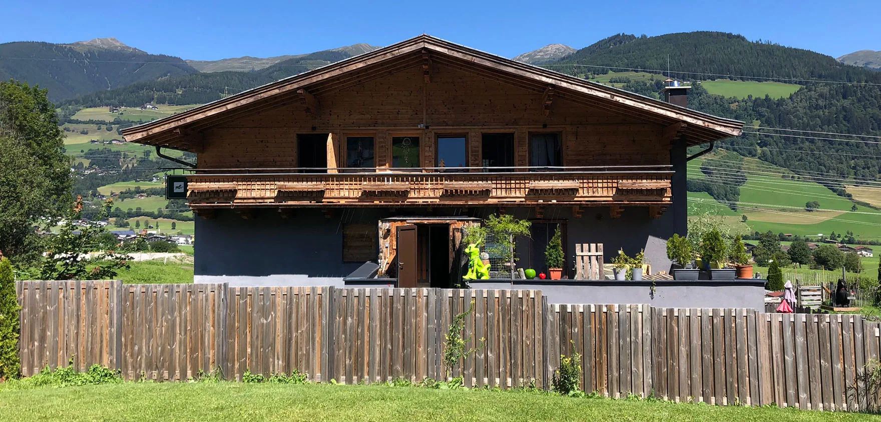 DogMountainInn with its garden and green mountains in summer